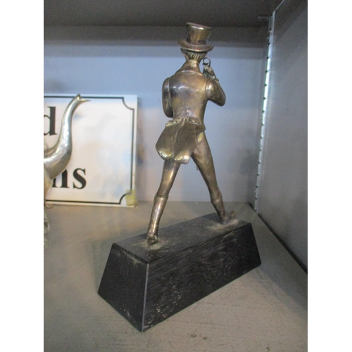 104 - A silver plated figurine of Johnnie Walker (Scotch Whisky) mounted on a rectangular base, 21.5cm hig... 