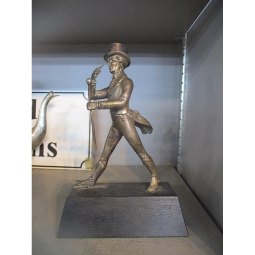 104 - A silver plated figurine of Johnnie Walker (Scotch Whisky) mounted on a rectangular base, 21.5cm hig... 