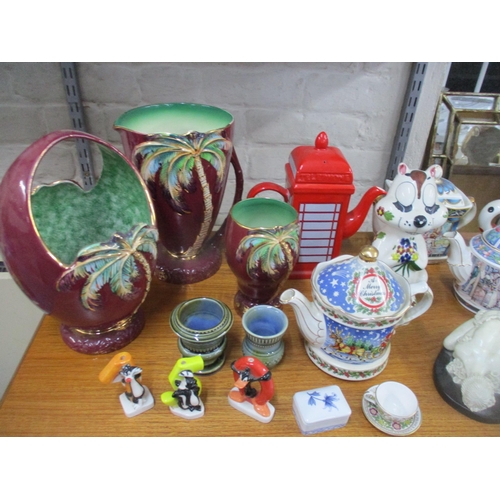 107 - A mixed lot of ceramics to include various novelty teapots, Beswick vases and a basket, Cascades Clo... 