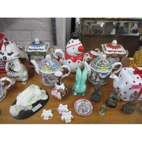 107 - A mixed lot of ceramics to include various novelty teapots, Beswick vases and a basket, Cascades Clo... 