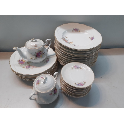 164 - A mid 20th century large dinner service in the French style having a white ground with floral sprays... 