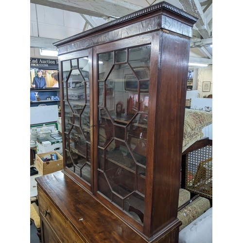 15 - A Regency mahogany secretaire bookcase having two astragal glazed doors above drawer with fitted int... 