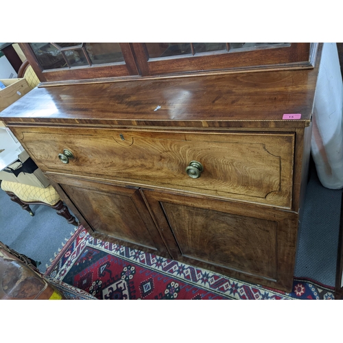 15 - A Regency mahogany secretaire bookcase having two astragal glazed doors above drawer with fitted int... 