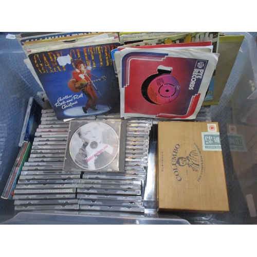 124 - A mixed collection of CDs, DVDs, 45rpm singles records, mounted, and framed and glazed Disney pictur... 