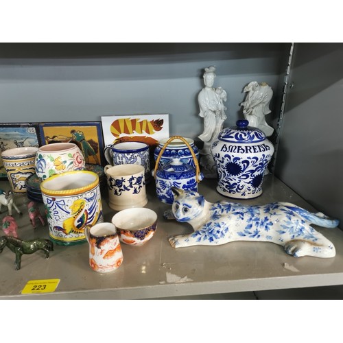 223 - A collection of mixed ceramics to include a blue and white model of a cat a/f, a large Poole pottery... 