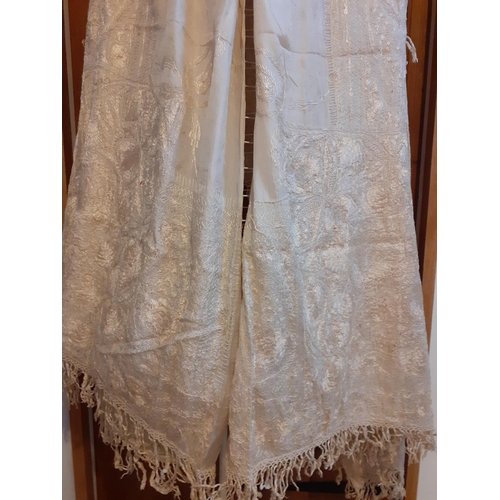 266 - A late 19th/early 20th Century cream double layered silk crinoline shawl heavily hand embroidered in... 