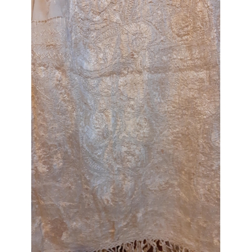 266 - A late 19th/early 20th Century cream double layered silk crinoline shawl heavily hand embroidered in... 