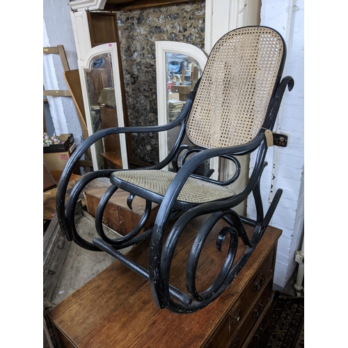 295 - An early 20th century black lacquered bentwood rocking chair
Location: G