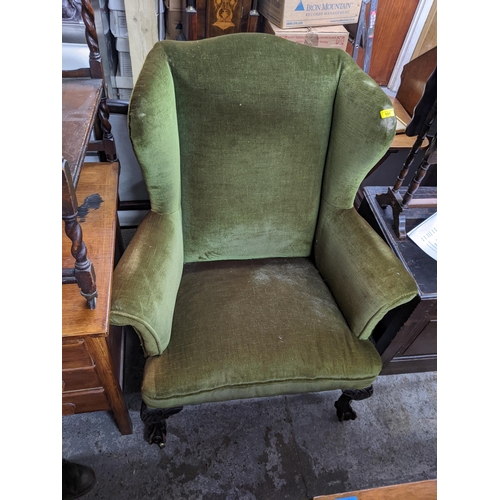 101 - A 1920s wingback armchair, on cabriole legs, ball and clawer feet
Location: G