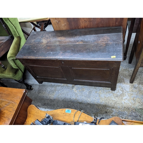 103 - An 18th century oak chest with a hinged top over a panelled front A/F
Location: G