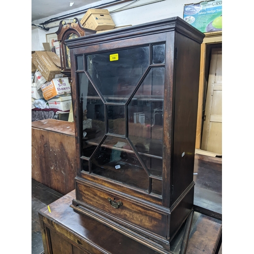 108 - A George III mahogany cabinet on cabinet, the upper part with a glazed door, over a drawer, on brack... 