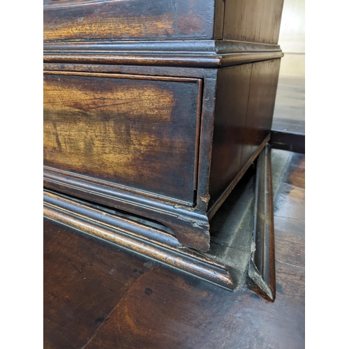 108 - A George III mahogany cabinet on cabinet, the upper part with a glazed door, over a drawer, on brack... 