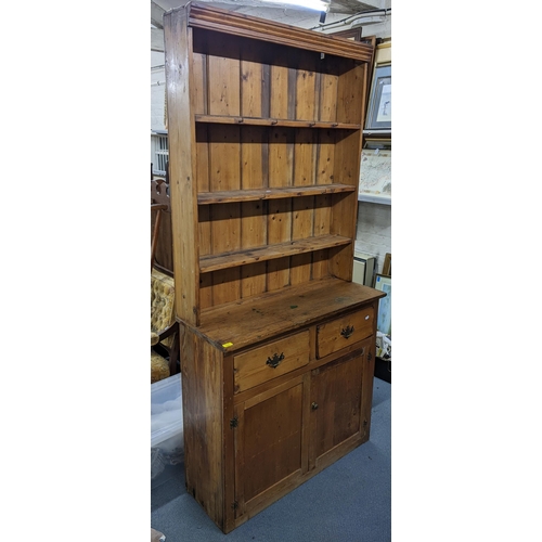 123 - A Victorian pine narrow dresser having a plate rack above two drawers and two cupboards, 219cm h x 1... 