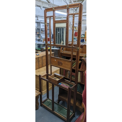 125 - An early 20th century oak hall stand with mirror, coat hooks and drip tray below 197cm h x 75cm w A/... 