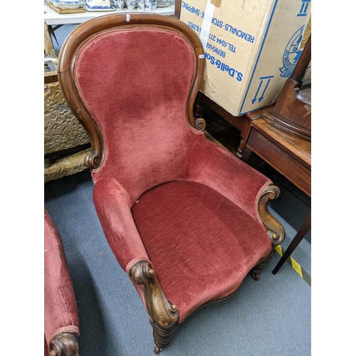 128 - A pair of Victorian mahogany spoon back salon armchairs having scroll shaped arms and turned legs Lo... 