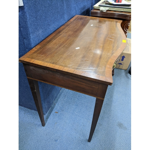 129 - A George III mahogany serpentine fronted side table having parquetry inlaid, single drawer and taper... 