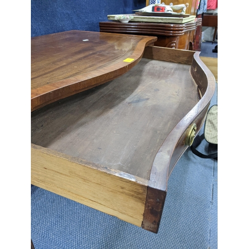 129 - A George III mahogany serpentine fronted side table having parquetry inlaid, single drawer and taper... 