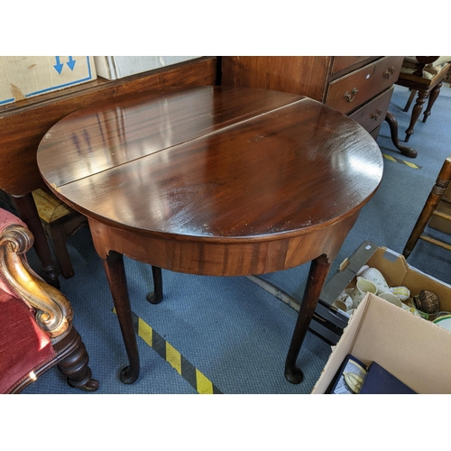 130 - A Georgian mahogany foldover card table having turned legs and pad shaped feet 71cm h x 84cm w Locat... 