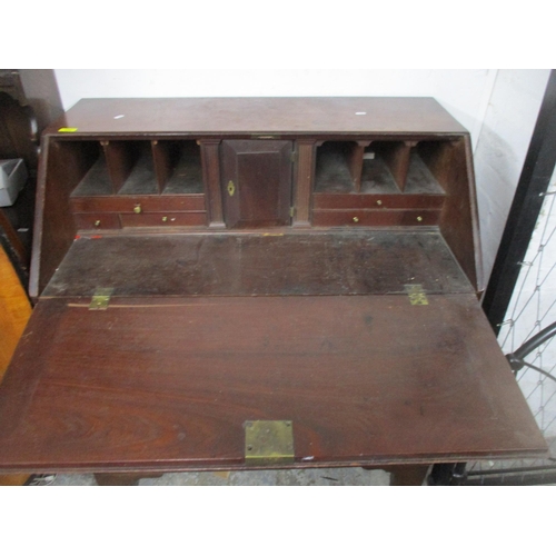 132 - A Georgian mahogany bureau of one short and three long graduated drawers, fall flap revealing a pige... 