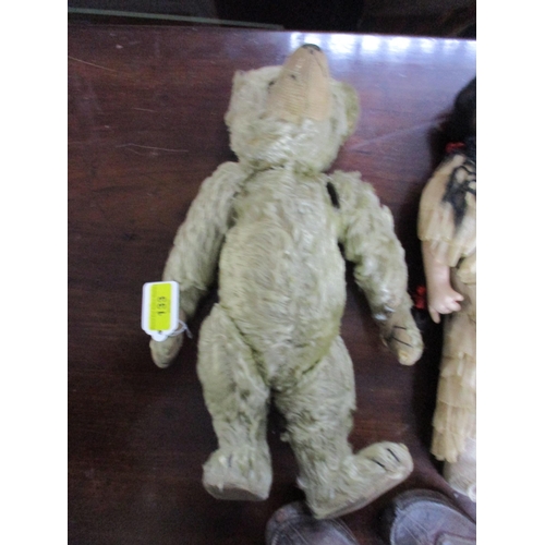 133 - An early 20th century teddy bear with jointed limb and boot button eyes 33cm long A/F, an Asian clot... 