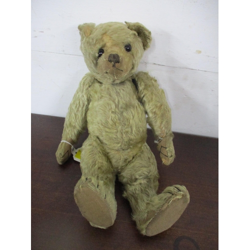 133 - An early 20th century teddy bear with jointed limb and boot button eyes 33cm long A/F, an Asian clot... 