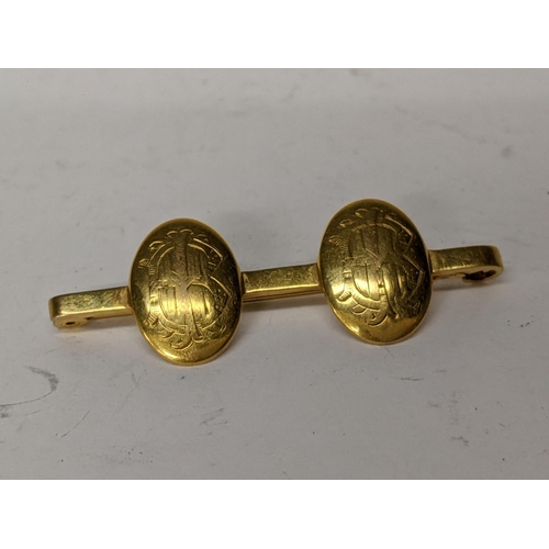 15 - A 9ct gold bar brooch with two roundels engraved with initials, 6.3g
Location:CAB5