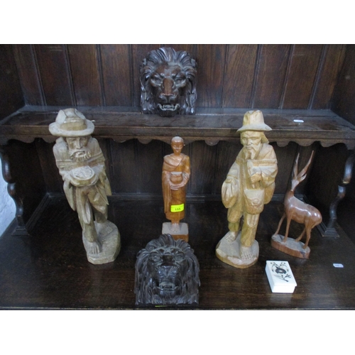 155 - A selection of carved wooden items to include two oak lion heads, Asian carved figures and others al... 