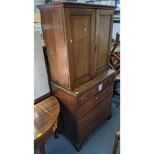 196 - A Georgian mahogany chest of drawers having a matched two-door cabinet to the top with two short and... 