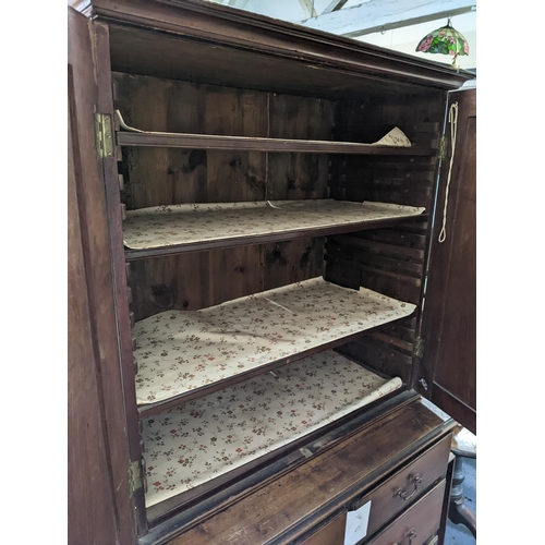 196 - A Georgian mahogany chest of drawers having a matched two-door cabinet to the top with two short and... 