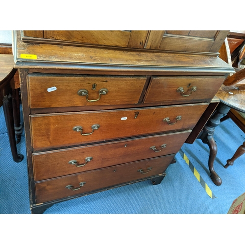 196 - A Georgian mahogany chest of drawers having a matched two-door cabinet to the top with two short and... 