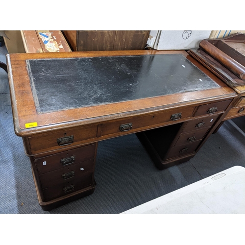 202 - A late 19th/early 20th century mahogany twin pedestal leather topped desk having one long and eight ... 