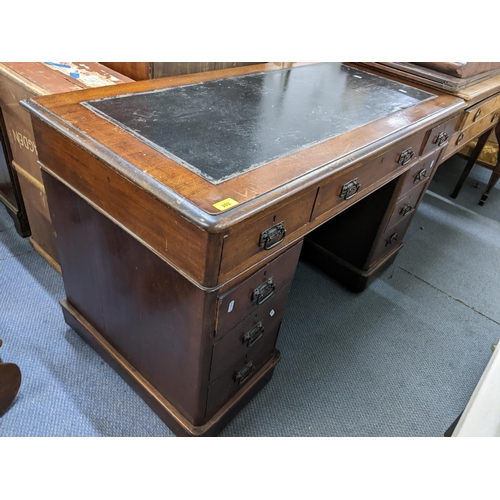 202 - A late 19th/early 20th century mahogany twin pedestal leather topped desk having one long and eight ... 