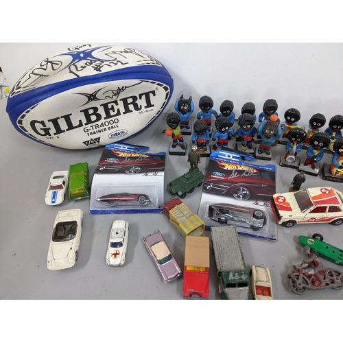 293 - A mixed lot to include Golly football and band figures, signed Rugby ball and toy cars to include Co... 