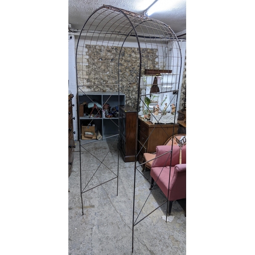 297 - A wrought iron garden arch, 224cm h x 83cm w
Location: G