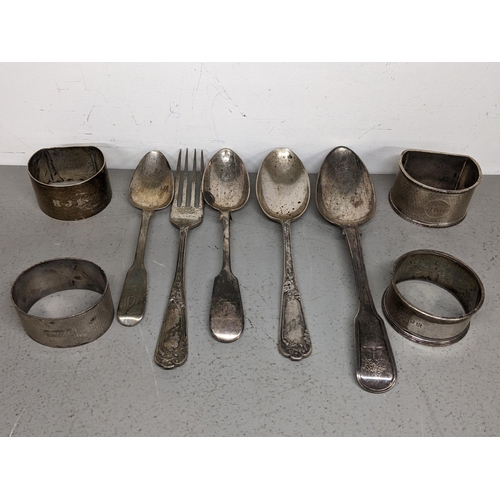 72 - Silver comprising four napkin rings, spoons and fork 287.7g Location: TABLE