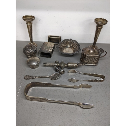 90 - Mixed silver to include a pair of posy vases (one weighted) baby rattle, sugar tongs, pin dish and o... 