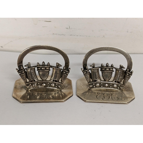 91 - A pair of silver naval name or menu holders stamped 'Page Plymouth Sterling Silver', to the bases, 4... 