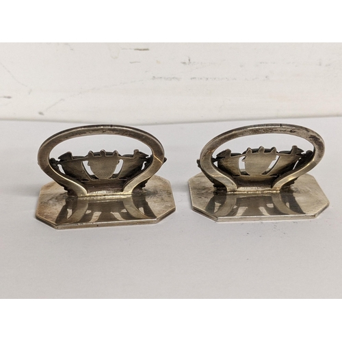 91 - A pair of silver naval name or menu holders stamped 'Page Plymouth Sterling Silver', to the bases, 4... 