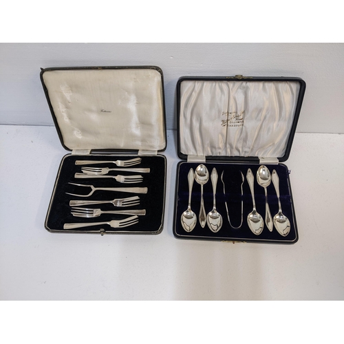 243 - Silver comprising a set of six teaspoons and matching tongs, and a set of six cake forks and serving... 