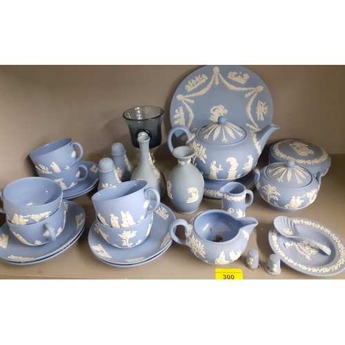 300 - A quantity of Wedgwood blue Jasper ware to include a teapot on stand, vases and six teacups with sau... 