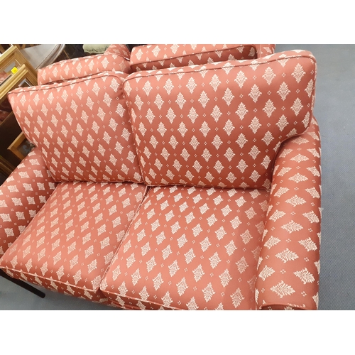 312 - Two two seater sofas in red with white floral sprays, in two sizes, 122cm w and 147cm w
Location: RA... 