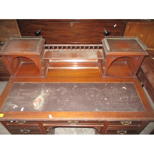 353 - Victorian mahogany kneehole writing desk, the top with mirrored back, below a galleried shelf flanke... 