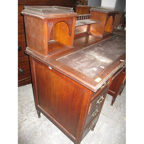 353 - Victorian mahogany kneehole writing desk, the top with mirrored back, below a galleried shelf flanke... 