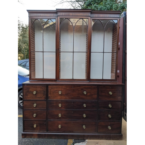 306 - A Regency mahogany secretaire bookcase having a stepped cornice above three glazed doors, pull down ... 