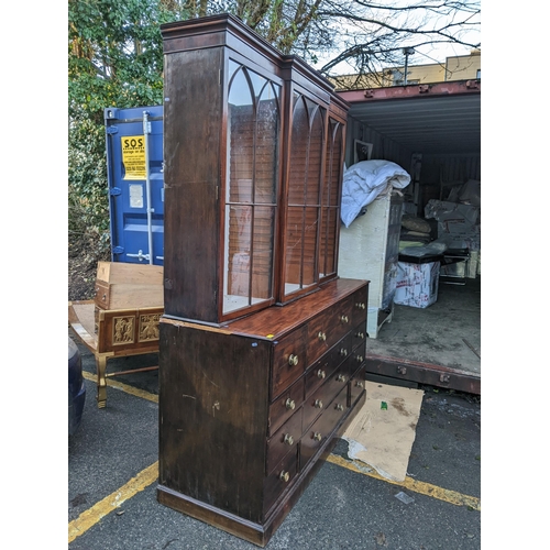 306 - A Regency mahogany secretaire bookcase having a stepped cornice above three glazed doors, pull down ... 