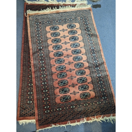 335 - A pair of Middle Eastern handwoven rugs having central elephant foot motifs, multi borders with tass... 