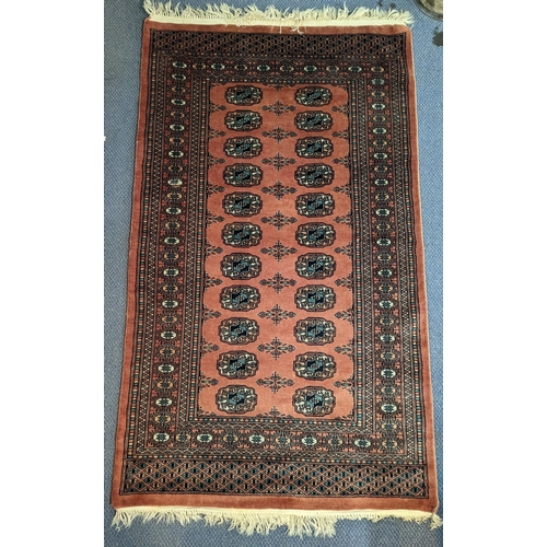 335 - A pair of Middle Eastern handwoven rugs having central elephant foot motifs, multi borders with tass... 