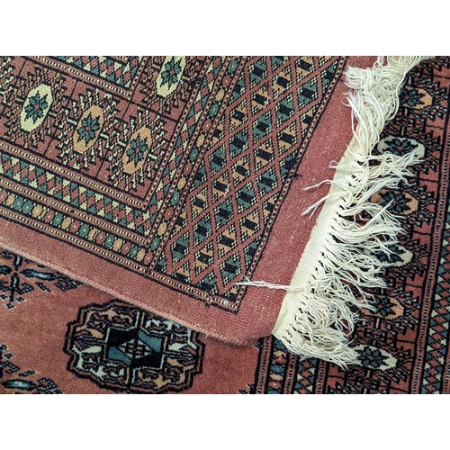 335 - A pair of Middle Eastern handwoven rugs having central elephant foot motifs, multi borders with tass... 