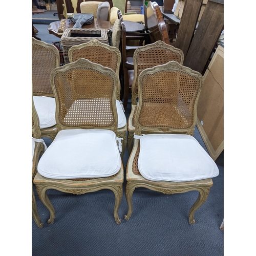 340 - A set of nine French painted dining chairs having cane upholstery, serpentine front and on cabriole ... 