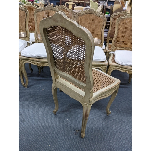 340 - A set of nine French painted dining chairs having cane upholstery, serpentine front and on cabriole ... 